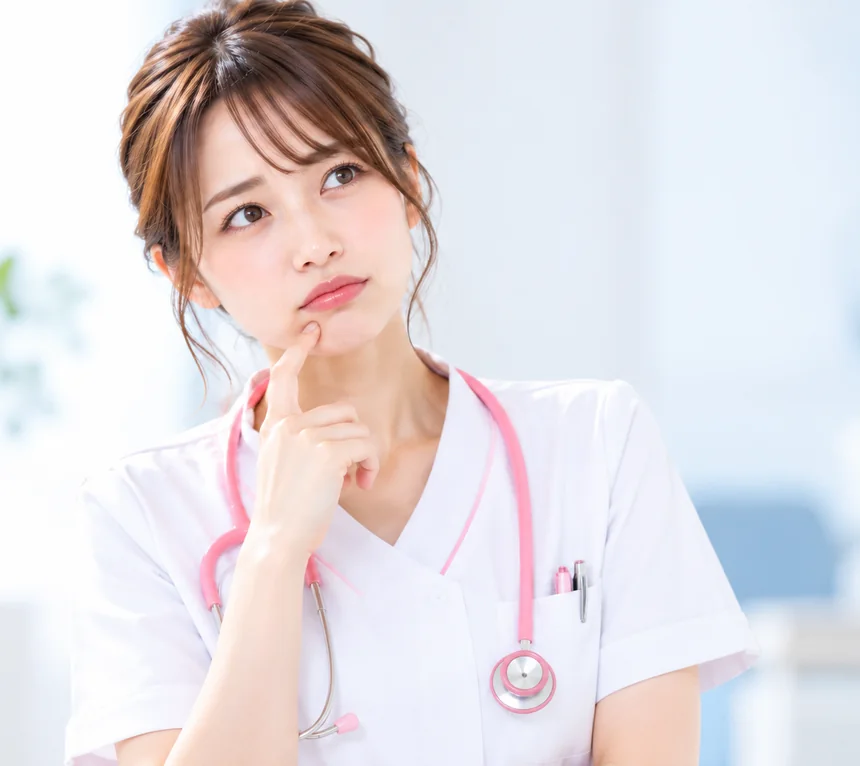 あごに指を当てて考え込む看護師